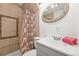 This charming bathroom features a tile shower, a neutral vanity, and new fixtures at 3306 S Logan St, Englewood, CO 80113