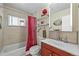 Bathroom with tub and shower, white tile surround, vanity and medicine cabinet at 3306 S Logan St, Englewood, CO 80113