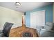 Bedroom featuring hardwood floors, blue accent wall, closet and a sitting chair at 3306 S Logan St, Englewood, CO 80113