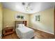 Bright bedroom with a ceiling fan, hardwood floors, and white bedspread at 3306 S Logan St, Englewood, CO 80113