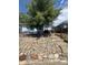 Exterior view of a house with attractive stone landscaping and a mature shade tree at 3306 S Logan St, Englewood, CO 80113