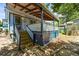 Exterior view of a blue home with a covered porch and wood stairs at 3306 S Logan St, Englewood, CO 80113