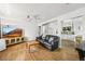Bright living room featuring hardwood floors, a ceiling fan and an open layout at 3306 S Logan St, Englewood, CO 80113