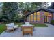 Brick house exterior, fire pit and backyard with green lawns, landscaping, treehouse and outdoor seating at 1328 E Layton Ave, Cherry Hills Village, CO 80113