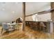 View of a spacious bar with modern wood details, chairs, and table at 1328 E Layton Ave, Cherry Hills Village, CO 80113