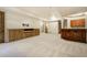 Spacious finished basement featuring carpet, custom built-ins, and a wet bar at 1328 E Layton Ave, Cherry Hills Village, CO 80113