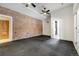 Spacious basement features exposed brick wall, and access to a bathroom through doorway at 1328 E Layton Ave, Cherry Hills Village, CO 80113