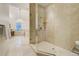 A glass shower is the focal point of this bathroom which boasts natural tile throughout at 1328 E Layton Ave, Cherry Hills Village, CO 80113