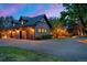Spacious three-car garage attached to a brick home with mature trees at 1328 E Layton Ave, Cherry Hills Village, CO 80113