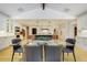 Bright, open kitchen with a large island and adjacent dining area at 1328 E Layton Ave, Cherry Hills Village, CO 80113