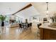 Bright, open living room flows into the kitchen with modern appliances, dining area, fireplace, and large windows at 1328 E Layton Ave, Cherry Hills Village, CO 80113
