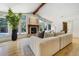 Comfortable living room with fireplace, beam and natural light at 1328 E Layton Ave, Cherry Hills Village, CO 80113