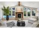 Cozy living room features a stone fireplace and view to the pool at 1328 E Layton Ave, Cherry Hills Village, CO 80113