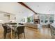 Open living and dining area with fireplace and large windows at 1328 E Layton Ave, Cherry Hills Village, CO 80113