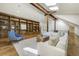 Well-lit living room boasting hard wood floors, large built-in bookshelf, and skylights at 1328 E Layton Ave, Cherry Hills Village, CO 80113