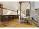 Open living space with hardwood flooring, brick fireplace, and a wet bar at 1328 E Layton Ave, Cherry Hills Village, CO 80113