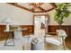 Bright office space featuring beautiful wood paneling, modern furnishings, and an open doorway to the rest of the home at 1328 E Layton Ave, Cherry Hills Village, CO 80113