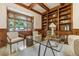 Wood-paneled office space featuring custom built-ins, large windows, and a modern glass desk at 1328 E Layton Ave, Cherry Hills Village, CO 80113