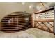 View of a wine room with unique shelving and stone backsplash at 1328 E Layton Ave, Cherry Hills Village, CO 80113