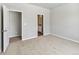 Comfortable bedroom featuring neutral carpeting and convenient access to en-suite bathroom at 869 Sawdust Dr, Brighton, CO 80601