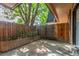 Private backyard with wooden fence and large tree at 7995 E Mississippi Ave # G5, Denver, CO 80247