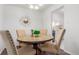 Small dining area with a wooden table and four chairs at 7995 E Mississippi Ave # G5, Denver, CO 80247