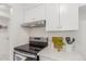 Kitchen with stainless steel range, white cabinets, and marble countertops at 7995 E Mississippi Ave # G5, Denver, CO 80247