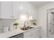 Clean kitchen featuring white cabinets and a double sink at 7995 E Mississippi Ave # G5, Denver, CO 80247