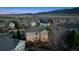 Aerial view of the back of a house with an outdoor patio setup at dusk, with mountains in the distance at 9375 S Hoyt Ct, Littleton, CO 80127