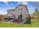 Spacious backyard with a stone patio featuring outdoor seating, perfect for entertaining guests at 9375 S Hoyt Ct, Littleton, CO 80127