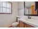Bright bathroom with a tiled countertop, basin sink, and a framed mirror at 9375 S Hoyt Ct, Littleton, CO 80127