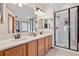 Bathroom features dual sinks, a granite countertop, and a glass-enclosed shower at 9375 S Hoyt Ct, Littleton, CO 80127
