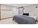 Comfortable bedroom featuring a cozy bed, a window, and neutral decor at 9375 S Hoyt Ct, Littleton, CO 80127
