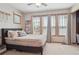 Comfortable bedroom boasts plenty of natural light from large windows and a cozy bed at 9375 S Hoyt Ct, Littleton, CO 80127