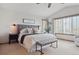 Spacious bedroom boasts a high ceiling, large windows, neutral decor, and a comfortable king-size bed at 9375 S Hoyt Ct, Littleton, CO 80127