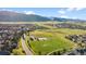 Picturesque community view with open green space, distant mountains, and a park at 9375 S Hoyt Ct, Littleton, CO 80127