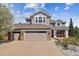Inviting two-story home features a two-car garage, a covered porch, and a well-maintained yard with mature trees at 9375 S Hoyt Ct, Littleton, CO 80127