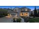 Charming two-story gray home with a well-manicured front yard, covered porch, and attached two-car garage at 9375 S Hoyt Ct, Littleton, CO 80127