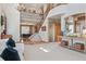 Inviting foyer with a grand staircase, soaring ceilings, decorative lighting, and an open view to the dining area at 9375 S Hoyt Ct, Littleton, CO 80127