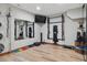 Home gym with hardwood floors and various workout equipment at 9375 S Hoyt Ct, Littleton, CO 80127