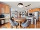 Open concept kitchen with stainless appliances, bar seating, and an eat-in kitchen table with backyard views at 9375 S Hoyt Ct, Littleton, CO 80127