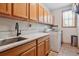 Convenient laundry room with counter space, cabinets, sink, and modern appliances at 9375 S Hoyt Ct, Littleton, CO 80127