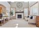 Open living room features a fireplace, large windows, neutral decor, and ample space for entertaining at 9375 S Hoyt Ct, Littleton, CO 80127