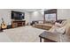 Cozy living room with a large sofa, soft carpet, and a media center at 9375 S Hoyt Ct, Littleton, CO 80127