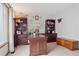 Home office includes built-in bookshelves, desk, and a cozy seating area at 9375 S Hoyt Ct, Littleton, CO 80127