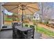 Inviting patio with a large table, umbrella, and additional seating, perfect for outdoor gatherings at 9375 S Hoyt Ct, Littleton, CO 80127