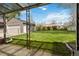 Large backyard with a lawn, detached garage, surrounded by a fence and trees on a sunny day at 4550 Zephyr St, Wheat Ridge, CO 80033