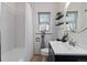 Bright bathroom featuring a vanity, toilet, tub, and shower with neutral colors and modern fixtures at 4550 Zephyr St, Wheat Ridge, CO 80033