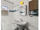 Bathroom featuring a pedestal sink, medicine cabinet, with tiled walls and mosaic detail above the bathtub at 4550 Zephyr St, Wheat Ridge, CO 80033