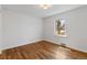 Inviting bedroom featuring hardwood floors, a large window, and neutral paint at 4550 Zephyr St, Wheat Ridge, CO 80033